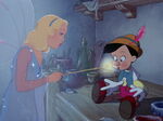 The Blue Fairy using magic to bring Pinocchio to life.