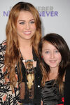 Miley Cyrus and her younger sister, Noah at premiere of Justin Bieber: Never Say Never in April 2011.