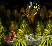 Donkey Kong about to throw a Vine Barrel at Queen B., as seen in the game Donkey Kong Country for SFC/SNES.