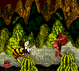 Donkey Kong about to throw a barrel at Queen B., as seen in the game Donkey Kong Country for GBC.