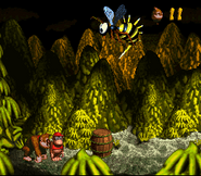 Queen B. about to land on Donkey and Diddy Kong, as seen in the game Donkey Kong Country for SFC/SNES.