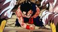 Gohan on his knees, holding his stomach