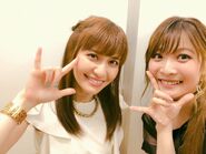 May'n and Megumi Nakajima posing for a selfie during the first day of the performance. May'n notes it's been a decade since Macross Frontier aired.[6]