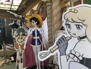 A cut-out of Sheryl Nome drawn in the Tezuka-style, standing beside Princess Knight.