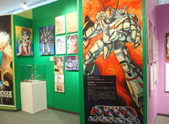 Various class Macross art by Haruhiko Mikimoto. Several toys and figures can also be found on display.