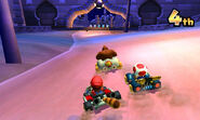 Mario, Toad, and Donkey Kong racing on the track.