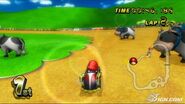 Baby Mario racing through Moo Moo Meadows in Mario Kart Wii.