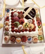 Cake and macarons made for Masahiro Sakurai's 49th birthday. A pink one with the Screw Attack is present beside the giant Smash symbol.[5]