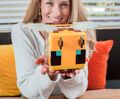 A woman holding an officially licensed bee moodlight.