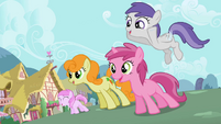 The ponies are entertained by the talents that Apple Bloom displays.