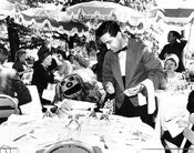 "After a morning of rehearsing, Rowlf takes time out to luncheon in plush outdoor restaurant. “Anything is fine as long as its not bones or canned canine canapes,” says the pooch."