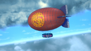 The blimp flying through the air.