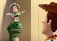 Woody looking at Mini Buzz on top of Rex.