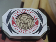 Boi's SaberTiger Dino Medal inserted into his Dino Buckler.