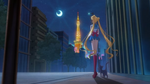 Sailor Moon standing along with Luna in the night.