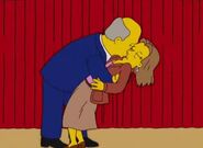 Principal Upfoot and Superintendent Chalmers kiss.