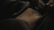 A Lucian Alliance member with a clan tattoo.