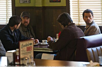 Dean, Bobby, Sam, and Castiel in Ervin's Diner.