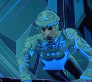 Since the glowing circuitry effect was achieved by putting black circuitry lines on a white costume and later matting them out to let the colored light shine through, anything else black (such as shadows) would have also been matted, thus explaining why Tron's circuitry has disappeared on the lower half of his body in this picture.