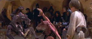 Sebulba being stopped by Anakin Skywalker from beating up Jar Jar.