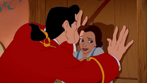 Gaston pinning Belle on her door to "win" her approval.