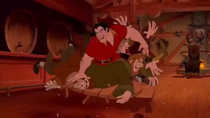 Gaston violently wrestling the buddies to overemphasize his strength.