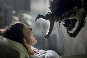 The Predalien about to impregnate a pregnant woman