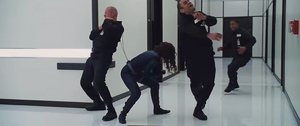 Black Widow fighting off several of Hammer's security guards.