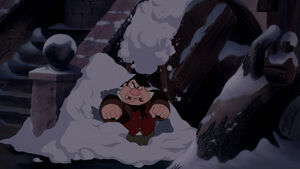 LeFou angry just as a pile of snow falls on top of him.