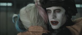 Harley embraces Joker after being freed from her cell.