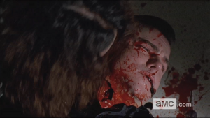 Gorman's throat is ripped out by the zombified Joan.