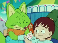 Konkichi gives a candy to a child