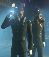 Two Bobbies wearing gas masks at night.