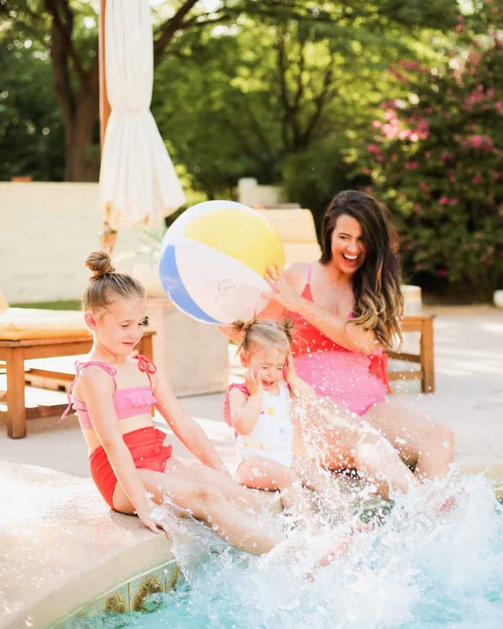 photo of a mom and daughters in mommy and me swimsuits from olivia and ocean by sugar and cloth