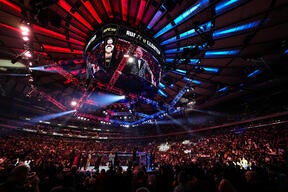 The energy builds at UFC 309 as fans gaze at the screen, eagerly awaiting the action to unfold at one of the most anticipated events in UFC history.