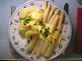 Sauce hollandaise on boiled white asparagus and potatoes