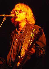 Mike Mills performing in 2009 with R.E.M. backing vocals, bass guitar