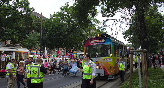 One of four rainbow-colored service trams at the front of the Rainbow Parade in Vienna