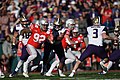 Ohio State Buckeyes defender chasing the Washington Huskies quarterback in the Rose Bowl