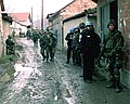 Soldiers from the U.S. Army's Bravo Company, 3rd Battalion, 504th Parachute Infantry Regiment, and United Nations' police in Mitrovica, Kosovo