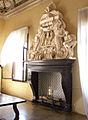 Carved marble mantlepiece around a fireplace