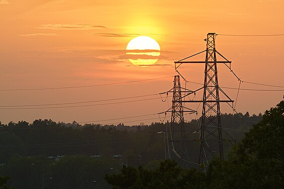 Setting sun and transmission towers. Flaten, Orhem, Stockholm, Sweden