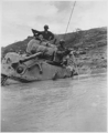 A tank sunk in 5 feet of water waits for towing equipment. Okinawa. 05/1945