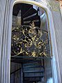 Library foyer: filigree rococo gates with spiral staircase