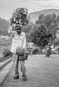 2nd Prize: A pot and drum seller on his way to work in Rwanda by Tuyizere Nkinzingabo Jean Pierre