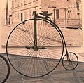 19th century style bicycle, sometimes called "penny farthing" style due to the different sizes of the wheels