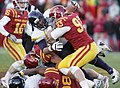 West Virginia Mountaineers being tackled by Iowa State Cyclones defenders