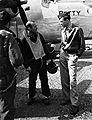 Maj. Jimmy Stewart confers with a B-24 crew member.