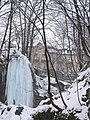 Iced waterfall in Lillafüred, with Palace Hotel.