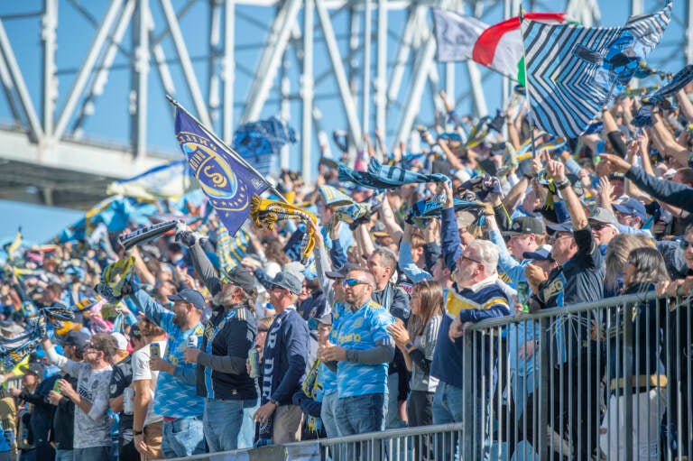 Fans cheer in a stadium.